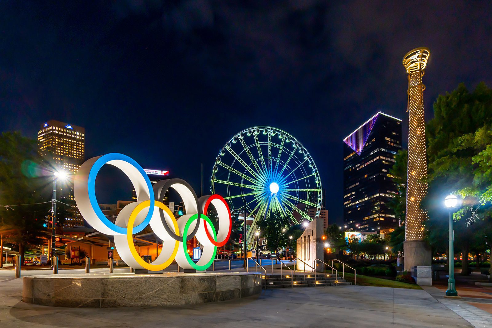 Olympic Rings and Light Tower Sculptures with the Sky View Ferris Wheel